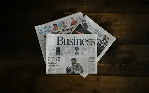 Folded business newspapers on a table