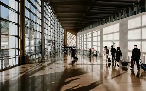 Travellers walking through an airport terminal